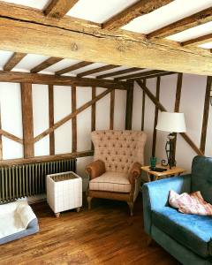 Cosy cottage living room with exposed beams and white FineLime plaster walls